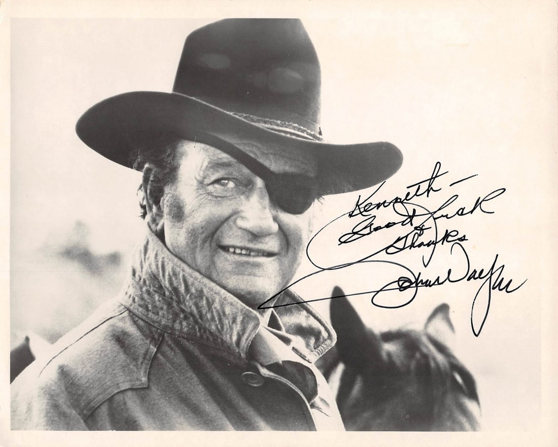 John Wayne True Grit Signed 8x10 Photo JSA Certified: John Wayne True Grit Signed 8x10 Photo JSA Certified This stunning 8x10 black and white photograph captures John Wayne in his iconic role from "True Grit." The photo features a heartfelt inscription, 