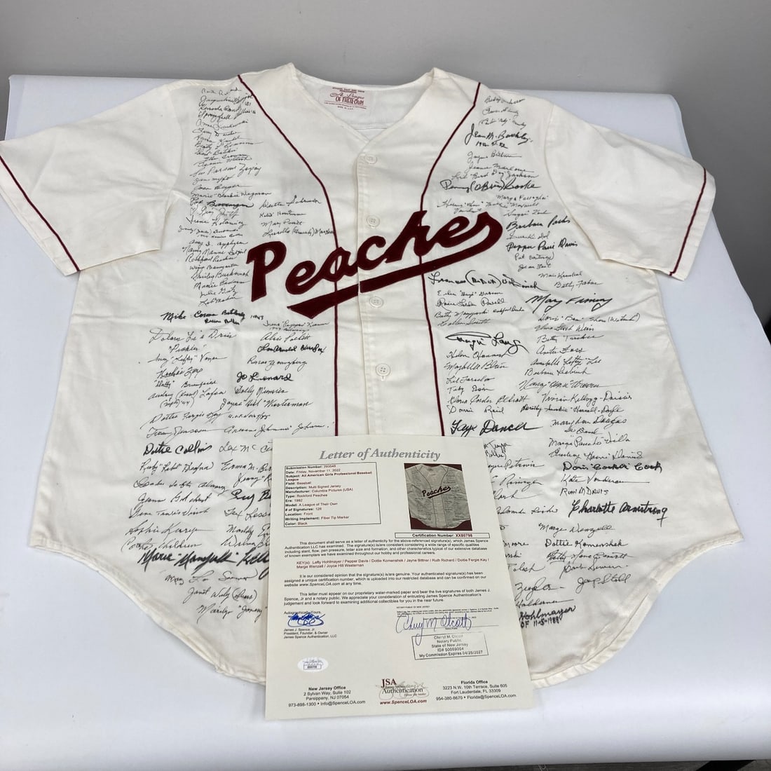 A League Of Their Own Rockford Peaches Signed Jersey 126 Signatures JSA COA: A League Of Their Own Rockford Peaches Signed Jersey 126 Signatures JSA COA This remarkable Rockford Peaches jersey is a true piece of sports history, celebrating the All-American Girls Professional B