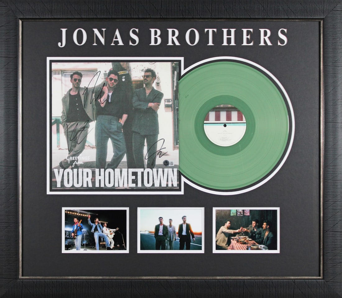 The Jonas Brothers Signed Framed Hometown Album Flat with Beckett COA: The Jonas Brothers Signed Framed Hometown Album Flat with Beckett COA This stunning, professionally framed photograph features the autographs of Nick Jonas, Joe Jonas, and Kevin Jonas from The Jonas B