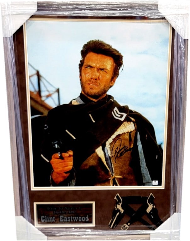 Clint Eastwood Hand Signed Framed 16x20 Photo JSA Authenticated: Clint Eastwood Hand Signed Framed 16x20 Photo JSA Authenticated This striking 16x20 photograph features Clint Eastwood in an iconic pose pointing a gun, beautifully custom framed for display. The piec