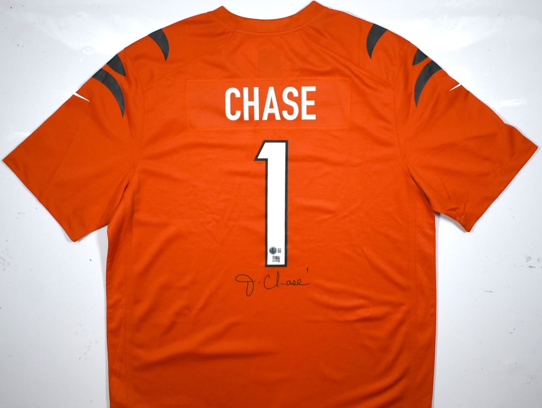 Nike Orange Game Jersey Signed by Ja'Marr Chase Beckett Hologram: Nike Orange Game Jersey Signed by Ja'Marr Chase Beckett Hologram Autographed orange Nike game jersey associated with Ja'Marr Chase. The jersey is pre-owned and includes a Beckett W hologram. Country o