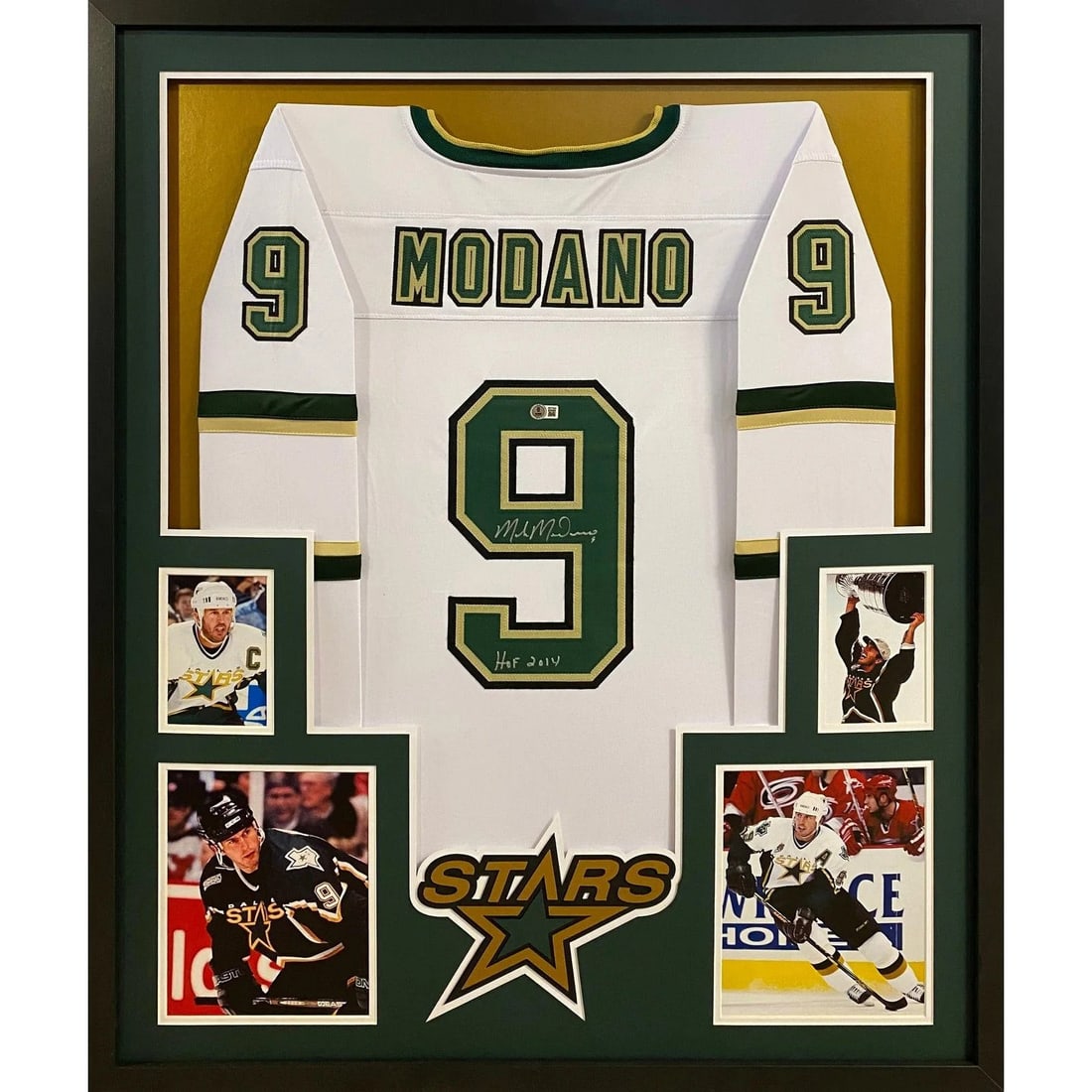 Framed Mike Modano Autographed White Dallas Stars Jersey Beckett COA: Framed Mike Modano Autographed White Dallas Stars Jersey Beckett COA This is a framed white Dallas Stars jersey autographed by Mike Modano. The jersey has been authenticated by Beckett and includes a 