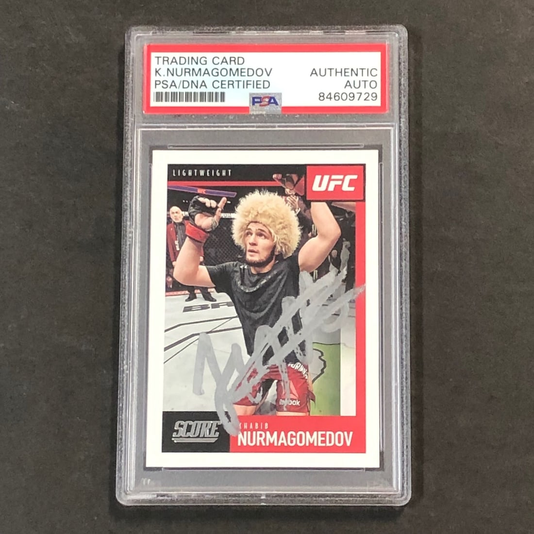 2021 Panini Score #98 Khabib Nurmagomedov Signed Card PSA Authenticated: 2021 Panini Score #98 Khabib Nurmagomedov Signed Card PSA Authenticated This is a 2021 Panini Score trading card featuring Khabib Nurmagomedov, a prominent figure in Mixed Martial Arts (MMA) and the U