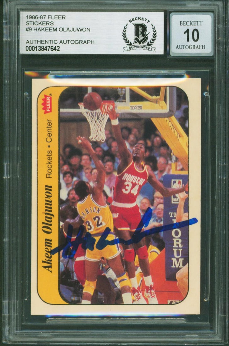 Hakeem Olajuwon Autographed 1986 Fleer Sticker #9 Card BAS Gem Mint 10 Slabbed: Hakeem Olajuwon Autographed 1986 Fleer Sticker #9 Card BAS Gem Mint 10 Slabbed This 1986 Fleer Stickers #9 basketball card features an authentic signature from Hakeem Olajuwon of the Houston Rockets. 