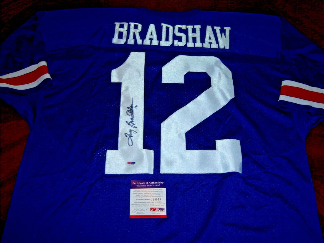 Terry Bradshaw Signed Russell Jersey with PSA/DNA Certification: Terry Bradshaw Signed Russell Jersey with PSA/DNA Certification This official licensed Russell jersey features the signature of football legend Terry Bradshaw, recognized for his remarkable career in 