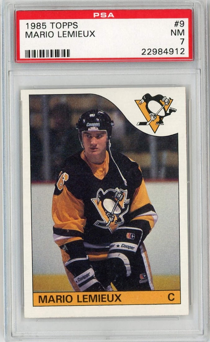 1985 Topps Mario Lemieux #9 Rookie Hockey Card PSA 7: 1985 Topps Mario Lemieux #9 Rookie Hockey Card PSA 7 This is a graded 1985 Topps Mario Lemieux #9 rookie hockey card, encapsulated and authenticated by Professional Sports Authenticator (PSA) with a g