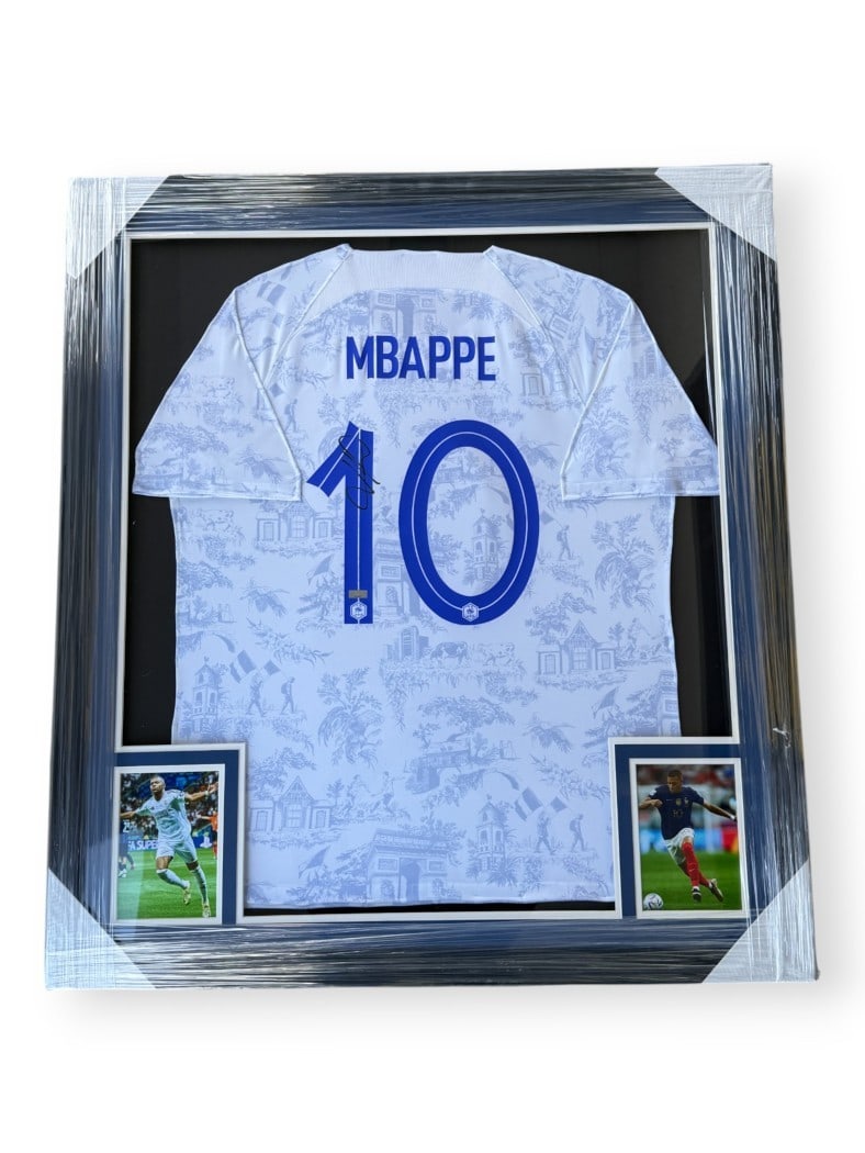Framed France Replica Jersey Signed by Kylian Mbappe with PSA Authentication: Framed France Replica Jersey Signed by Kylian Mbappe with PSA Authentication This framed France National Team replica jersey is autographed by Kylian Mbappe. The jersey comes with a Panini sticker and