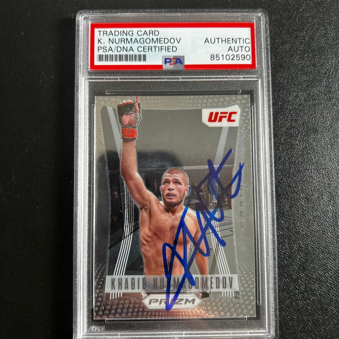 2022 Panini Prizm Khabib Nurmagomedov Autographed Card PSA Certified: 2022 Panini Prizm Khabib Nurmagomedov Autographed Card PSA Certified This is a 2022 Panini Prizm #1 sports trading card featuring the signature of Khabib Nurmagomedov, a renowned UFC fighter. The card