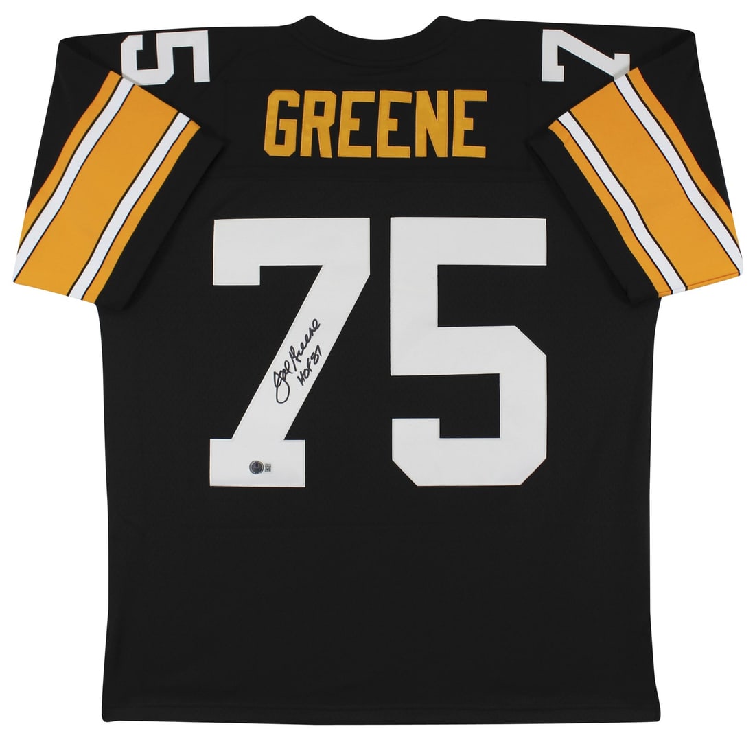 Joe Greene Signed Mitchell and Ness Black Throwback Jersey HOF 87 Beckett: Joe Greene Signed Mitchell and Ness Black Throwback Jersey HOF 87 Beckett Autographed Black Mitchell & Ness 1976 throwback jersey signed by Joe Greene with the inscription "HOF 87." It is an original 