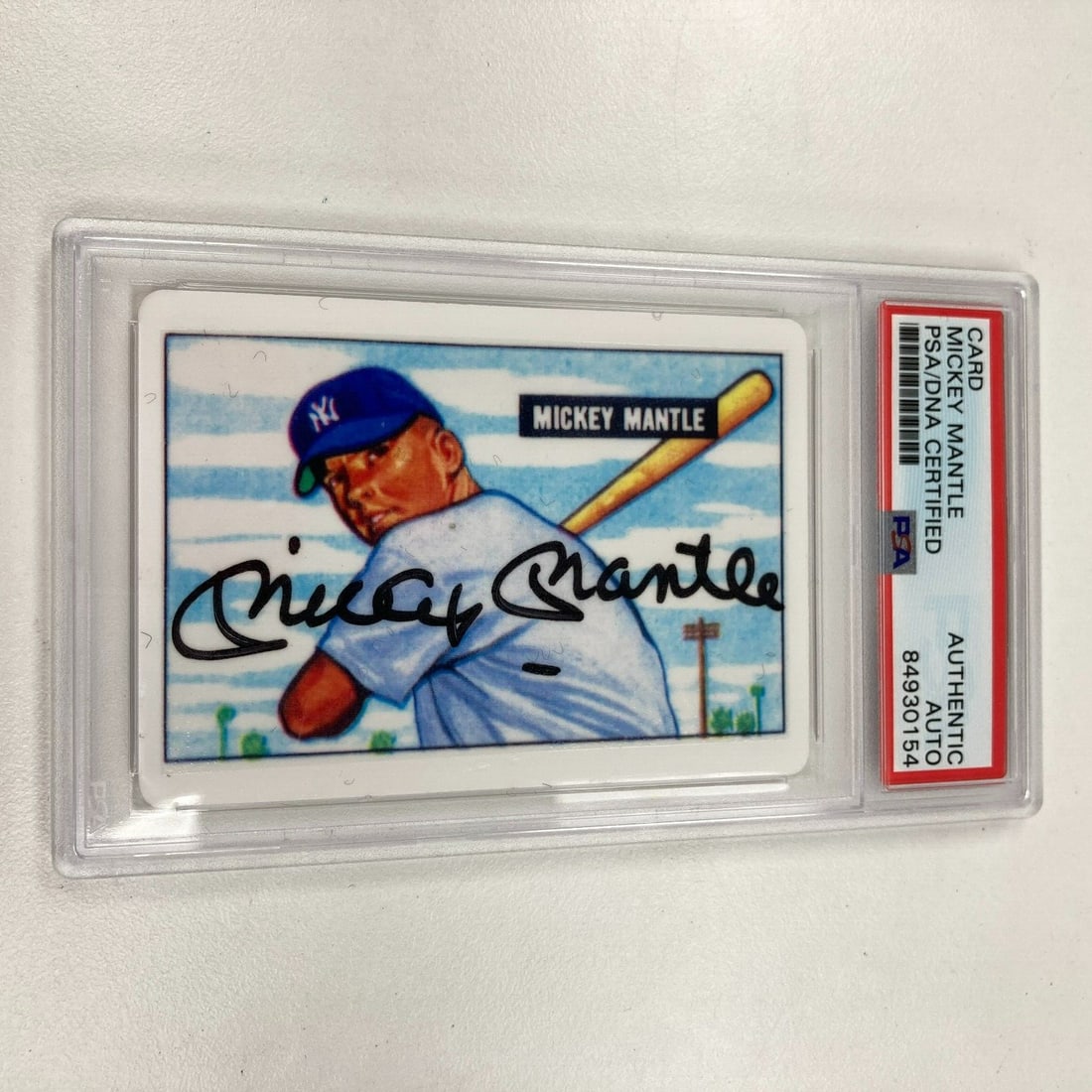 1951 Bowman Mickey Mantle Signed Baseball Card PSA Certified: 1951 Bowman Mickey Mantle Signed Baseball Card PSA Certified This is a 1951 Bowman Mickey Mantle Signed Porcelain Baseball Card, an iconic piece for any baseball collector. The card is hard signed and