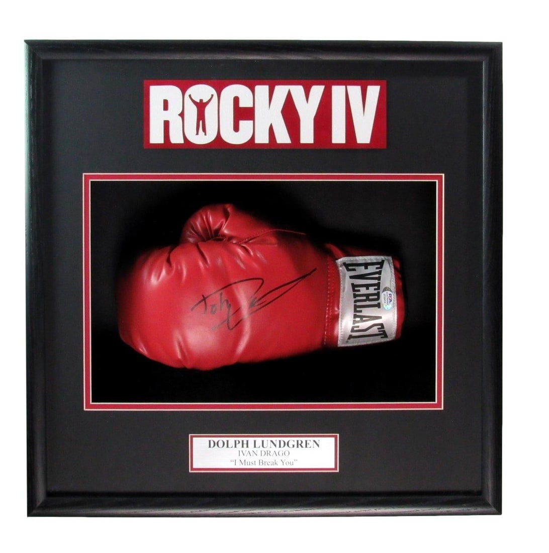 Dolph Lundgren Signed Boxing Glove Rocky IV Framed PSA/DNA 19x19: Dolph Lundgren Signed Boxing Glove Rocky IV Framed PSA/DNA 19x19 This impressive piece features a signed left boxing glove by Dolph Lundgren from the iconic film "Rocky IV," beautifully framed for dis