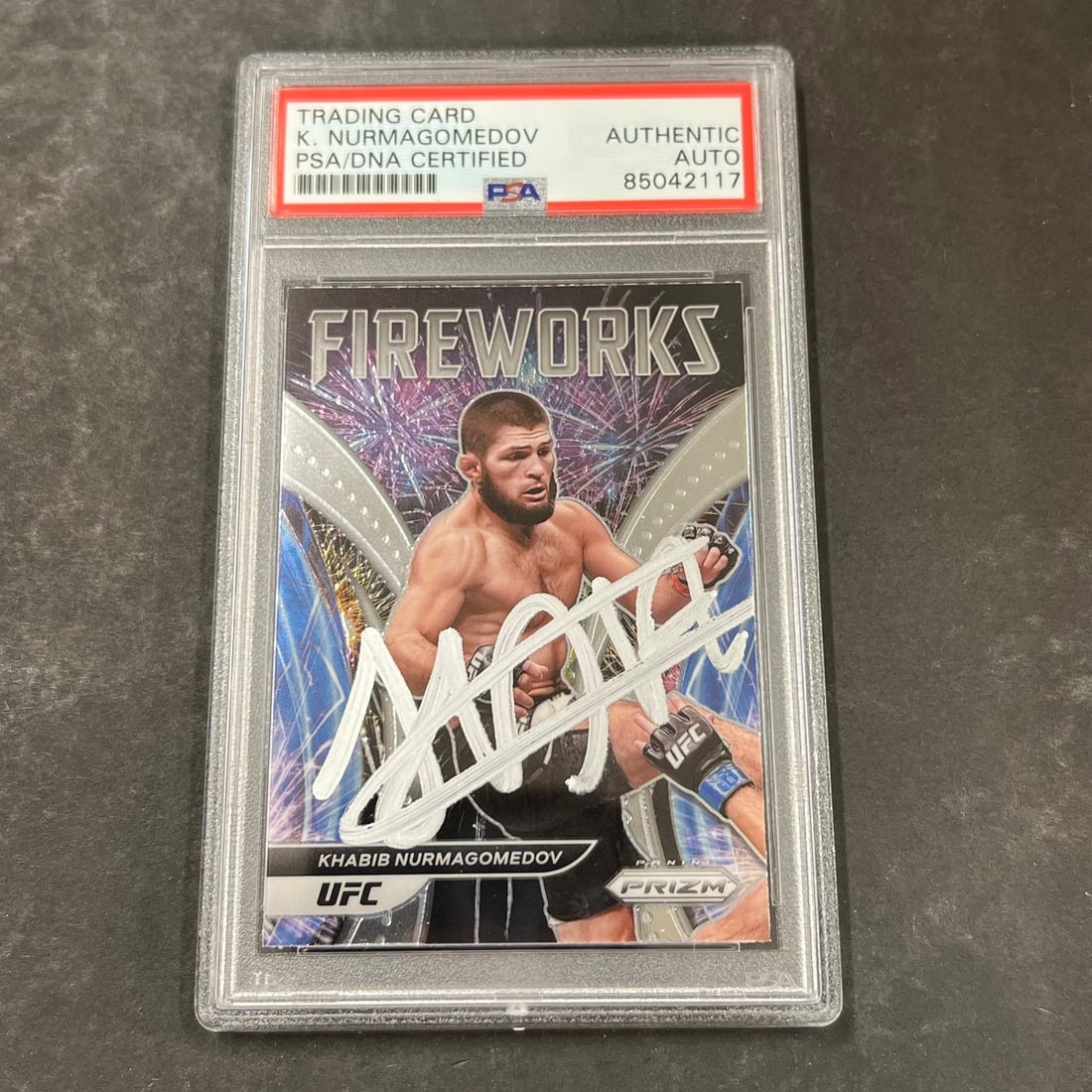 Khabib Nurmagomedov PSA Autographed Prizm UFC Fireworks Card #5: Khabib Nurmagomedov PSA Autographed Prizm UFC Fireworks Card #5 This is a 2022 Panini Prizm UFC #5 sports trading card featuring Khabib Nurmagomedov. The card is autographed by Khabib Nurmagomedov and