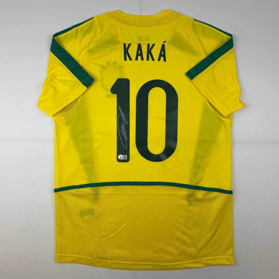 Signed Ricardo Kaka Brazil Soccer Jersey with Beckett Authentication: Signed Ricardo Kaka Brazil Soccer Jersey with Beckett Authentication This authentic, autographed Brazil yellow soccer jersey features the signature of renowned athlete Ricardo Kaka. The jersey is veri