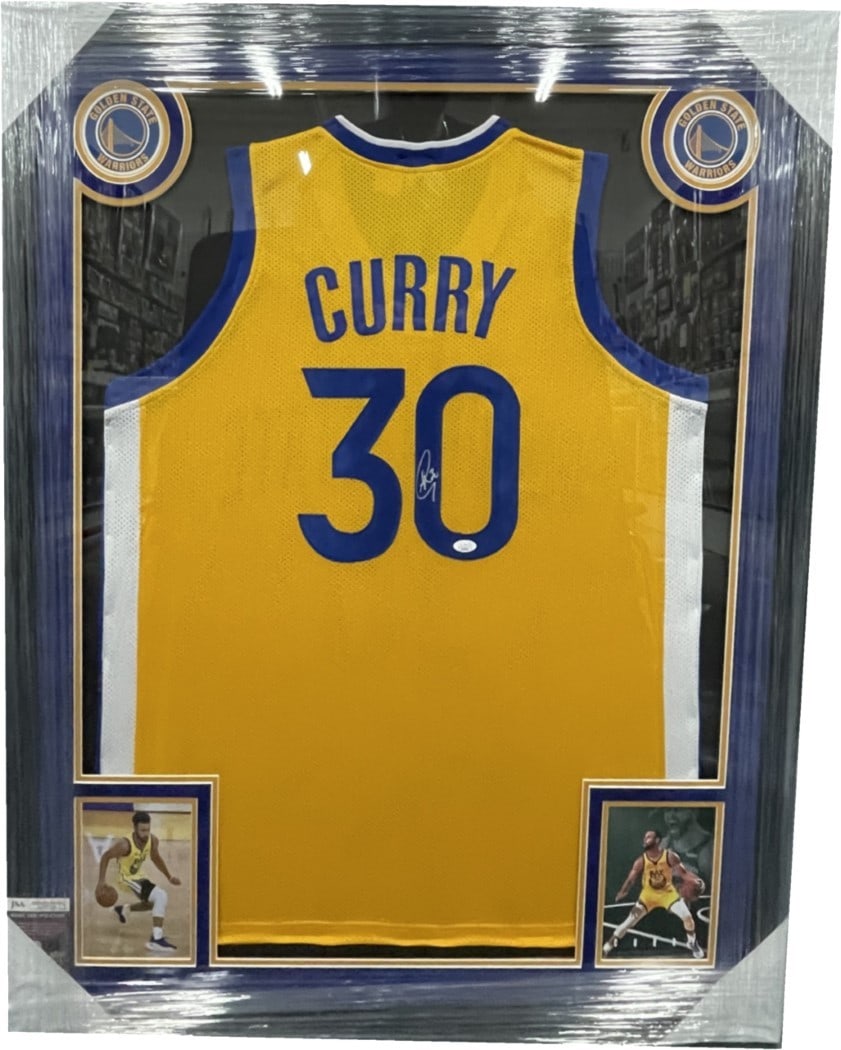 Stephen Curry Autographed Jersey Custom Framed 35x43 JSA Authenticated Warriors: Stephen Curry Autographed Jersey Custom Framed 35x43 JSA Authenticated Warriors This is a custom framed autographed jersey of Steph Curry, a star player for the Golden State Warriors. The jersey is au