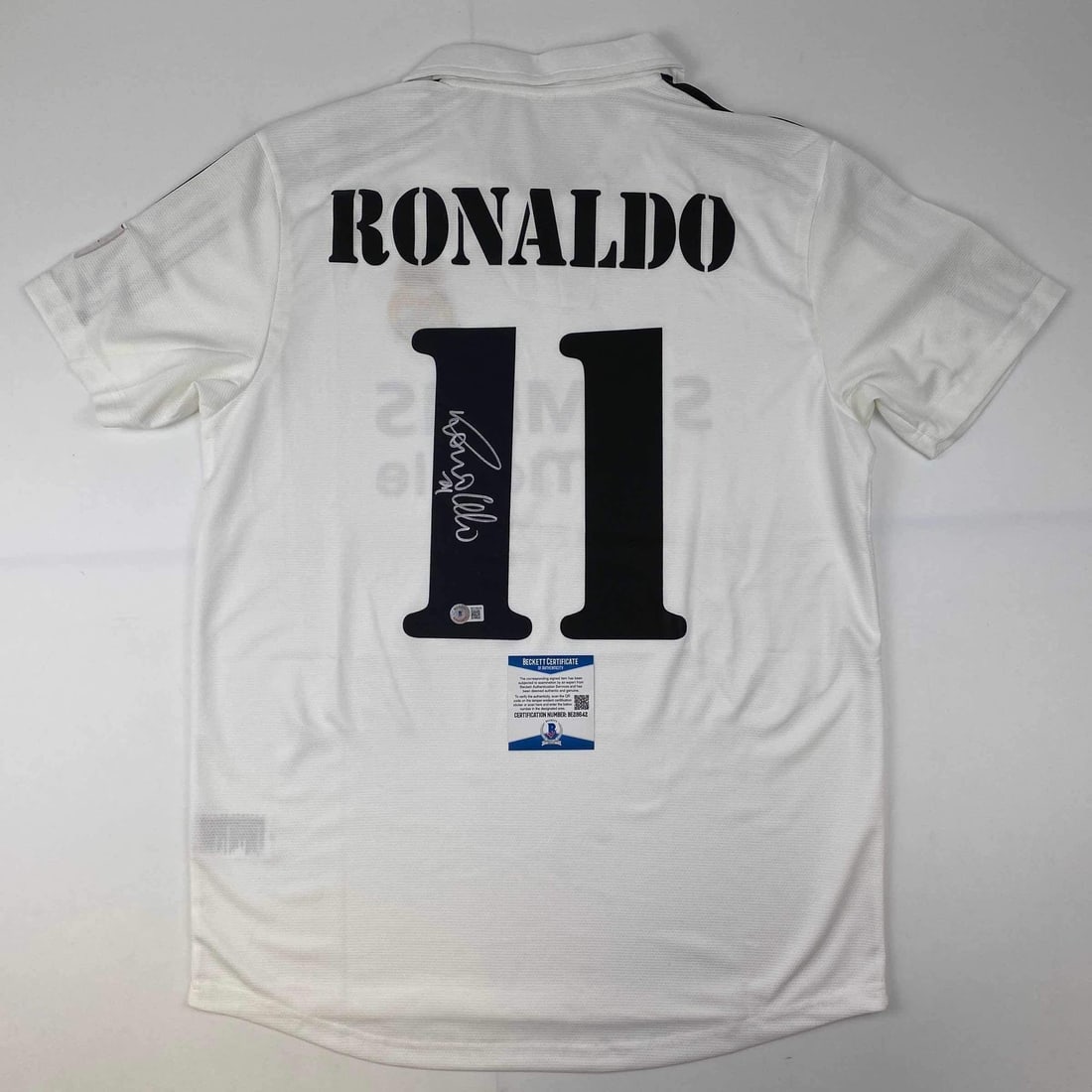 Ronaldo Nazario Signed Real Madrid Custom White Jersey Beckett BAS COA: Ronaldo Nazario Signed Real Madrid Custom White Jersey Beckett BAS COA Autographed Ronaldo Nazario Real Madrid white custom jersey intended as a collectible display piece. The jersey features the play