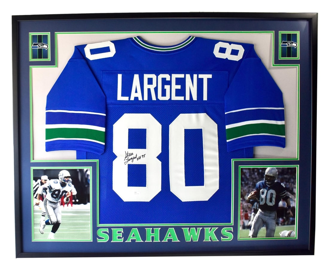Framed Steve Largent Signed Seattle Seahawks Jersey with HOF Inscription JSA Authenticated: Framed Steve Largent Signed Seattle Seahawks Jersey with HOF Inscription JSA Authenticated This is a professionally framed Seattle Seahawks jersey autographed and inscribed "HOF" by Steve Largent, one