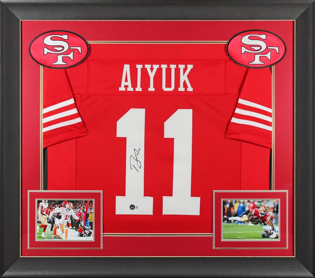 Brandon Aiyuk signed framed red jersey Beckett BAS Witnessed: Brandon Aiyuk signed framed red jersey Beckett BAS Witnessed This autographed red pro style framed jersey has been personally signed by Brandon Aiyuk of the San Francisco 49ers. It is an original, han