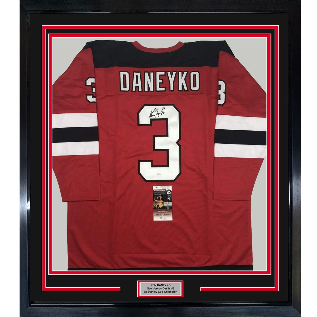 Ken Daneyko signed framed Devils jersey display 33x42 JSA COA: Ken Daneyko signed framed Devils jersey display 33x42 JSA COA This is a framed and autographed Ken Daneyko New Jersey Devils red jersey. The jersey is professionally framed and matted, featuring two 8