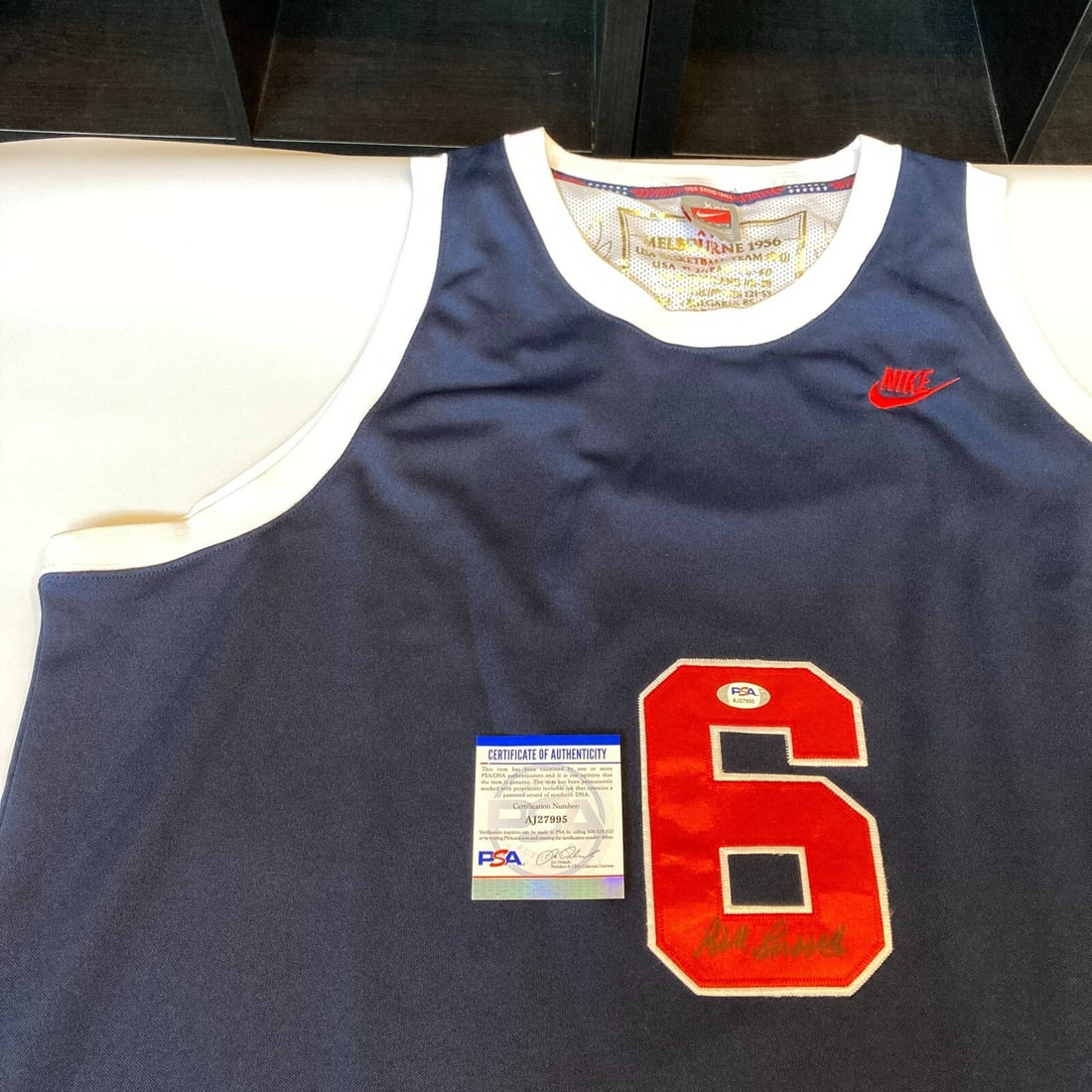 Bill Russell autographed Nike 1956 Team USA Olympics jersey PSA DNA COA: Bill Russell autographed Nike 1956 Team USA Olympics jersey PSA DNA COA This is a pre-owned Nike jersey signed by Bill Russell, commemorating the 1956 Team USA Olympics. The autograph has been authent