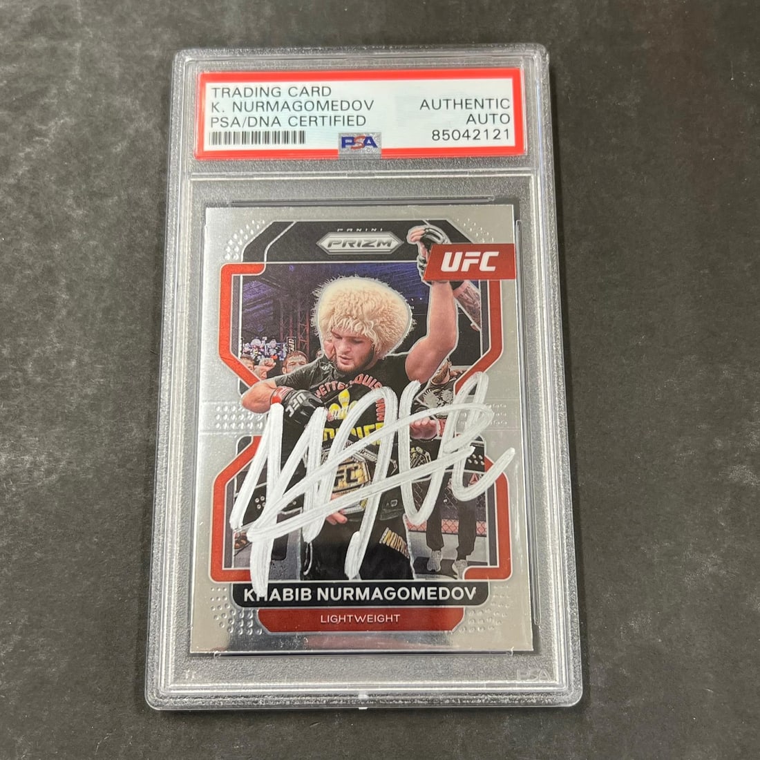 2022 Panini Prizm Khabib Nurmagomedov Signed Card PSA Authenticated: 2022 Panini Prizm Khabib Nurmagomedov Signed Card PSA Authenticated This is a 2022 Panini Prizm #196 sports trading card featuring Khabib Nurmagomedov, a celebrated athlete in the Ultimate Fighting Ch