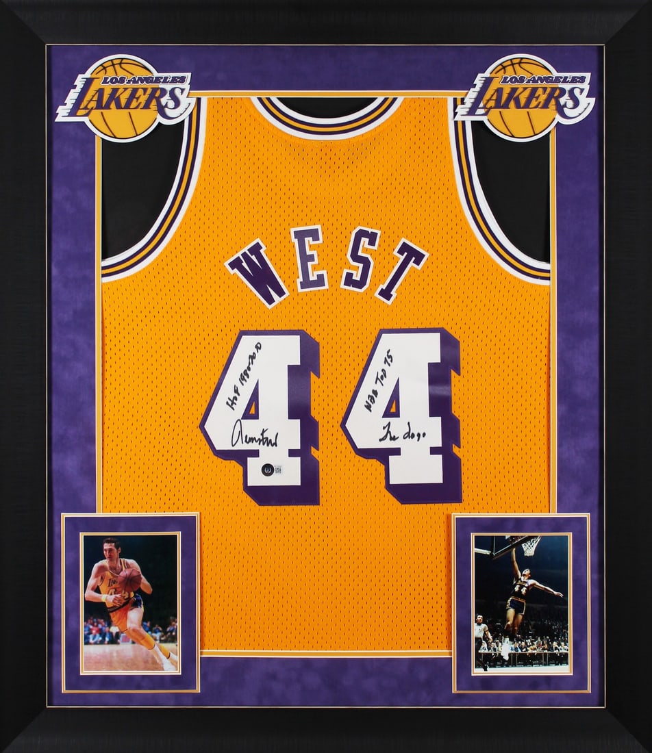 Jerry West Signed Framed Lakers Jersey with Inscriptions Beckett COA: Jerry West Signed Framed Lakers Jersey with Inscriptions Beckett COA Celebrate the legacy of Jerry West with this remarkable autographed yellow Mitchell & Ness Hardwood Classics Swingman jersey. This 