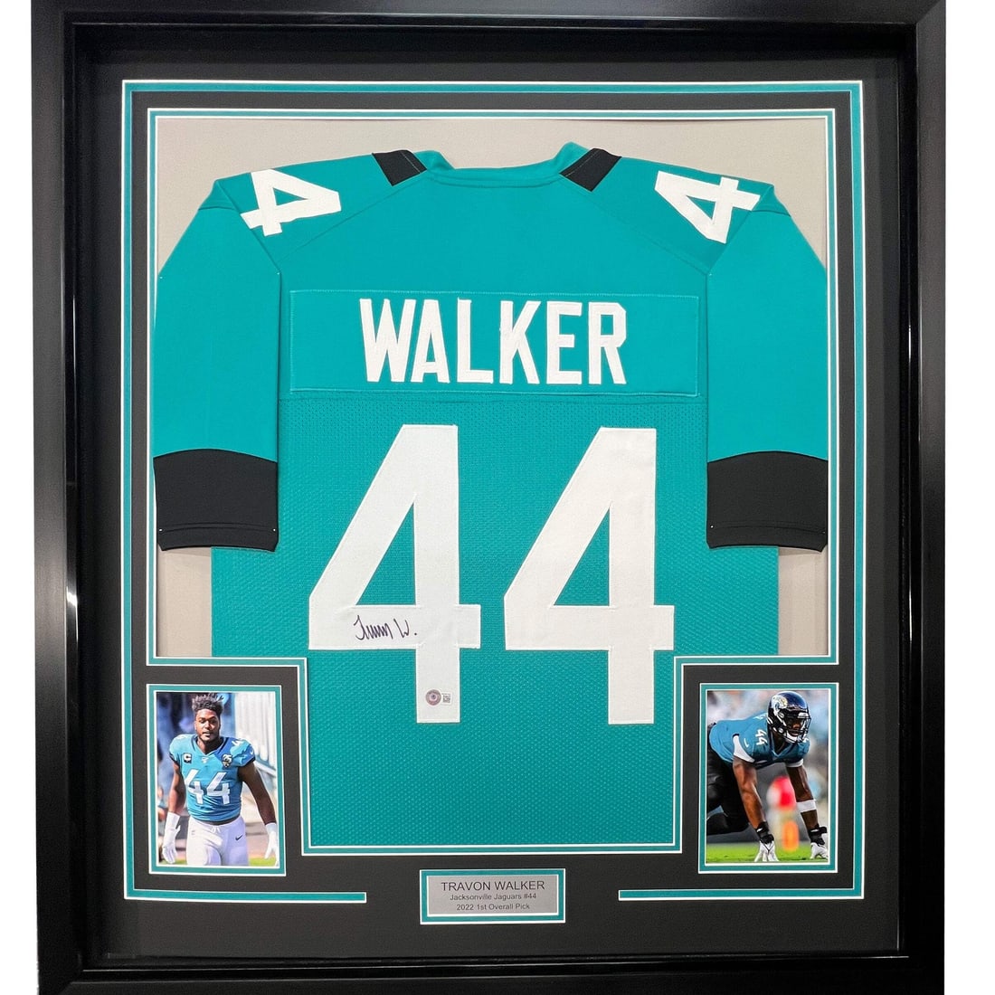 Travon Walker signed framed Jaguars teal jersey 33x42 Beckett COA: Travon Walker signed framed Jaguars teal jersey 33x42 Beckett COA This framed Jacksonville Jaguars teal jersey is autographed by Travon Walker. The jersey is professionally framed and matted, featurin