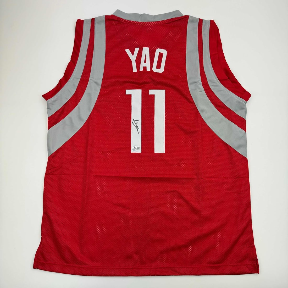 Yao Ming Signed Houston Rockets Basketball Jersey Beckett COA: Yao Ming Signed Houston Rockets Basketball Jersey Beckett COA This authentic autographed Yao Ming Houston Rockets red basketball jersey is a unique collectible for any NBA fan. The jersey features the