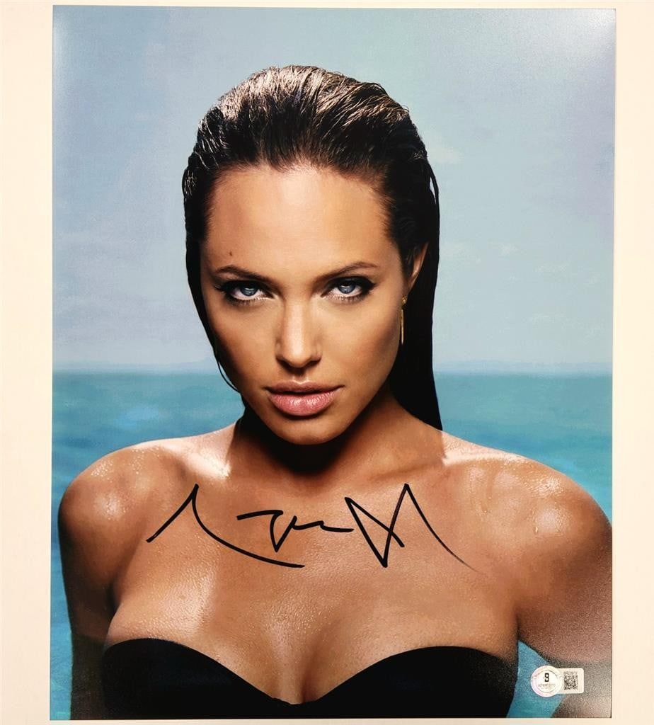11x14 Photograph Signed by Angelina Jolie as Lara Croft Beckett Authenticated: 11x14 Photograph Signed by Angelina Jolie as Lara Croft Beckett Authenticated This is an original 11x14 photograph signed by Angelina Jolie as Lara Croft. The autograph is authenticated by Beckett (BA