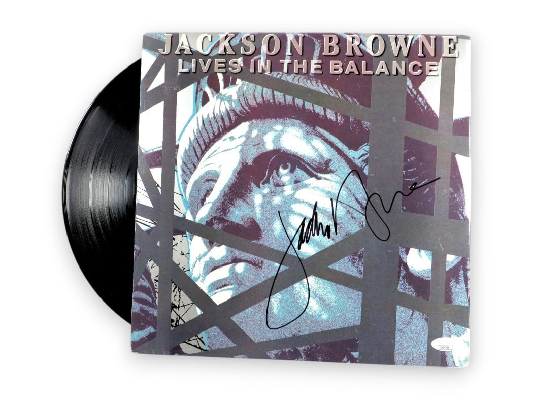 Jackson Browne Signed Album Cover Lives in the Balance JSA Authenticated: Jackson Browne Signed Album Cover Lives in the Balance JSA Authenticated This is an original album cover of Jackson Browne's 'Lives in the Balance', personally signed by the artist. The signature has 