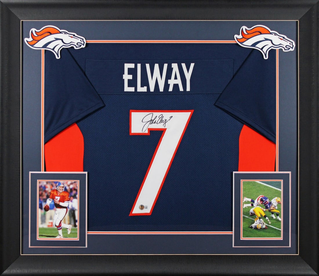 Framed Navy Pro Style Jersey Signed by John Elway Beckett Witnessed: Framed Navy Pro Style Jersey Signed by John Elway Beckett Witnessed This professionally framed navy blue pro style jersey has been personally signed by John Elway of the Denver Broncos. The autograph 