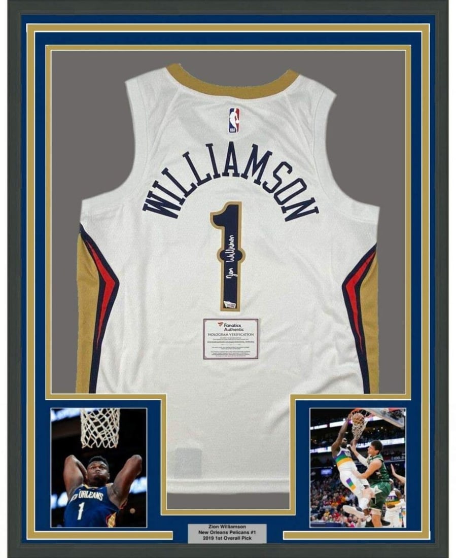 Framed Autographed Zion Williamson White Nike Jersey Fanatics COA: Framed Autographed Zion Williamson White Nike Jersey Fanatics COA This framed autographed jersey features Zion Williamson of the New Orleans Pelicans, showcasing his signature on a white Nike jersey. 
