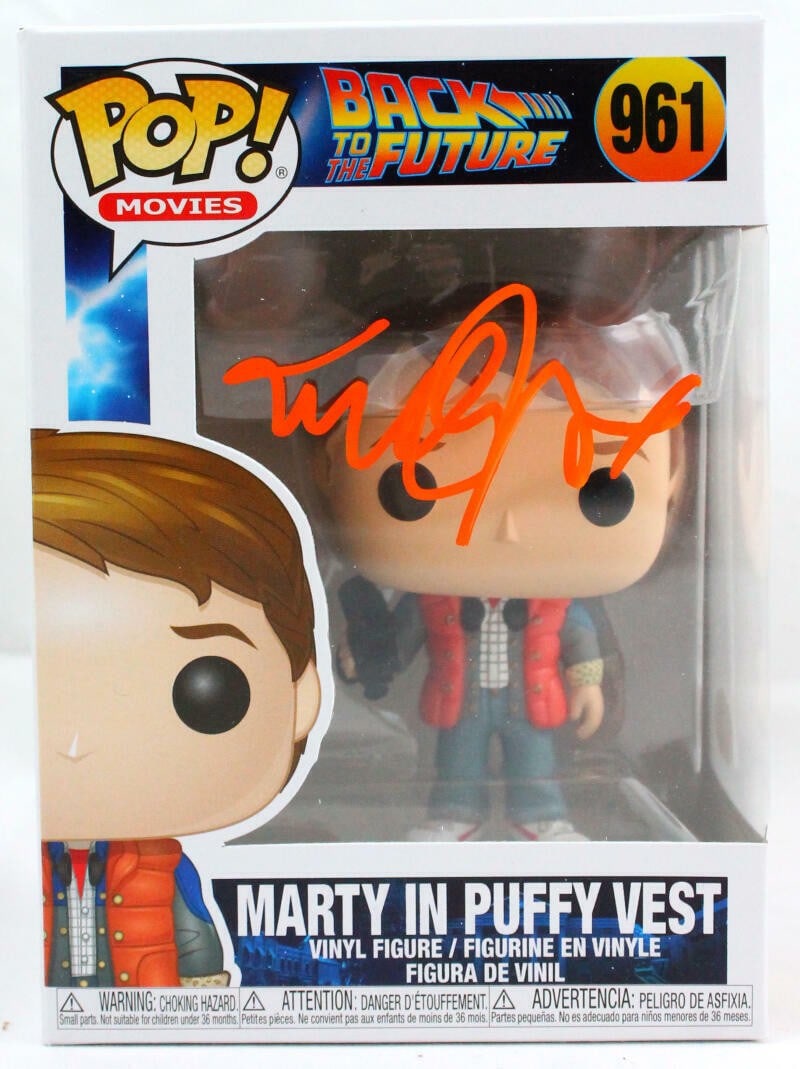 Funko Marty Puffy Vest Figure Signed by Michael J. Fox JSA #961: Funko Marty Puffy Vest Figure Signed by Michael J. Fox JSA #961 Funko Pop figurine #961 featuring Marty in a puffy vest, autographed by Michael J. Fox. The item is pre-owned and includes JSA W authent