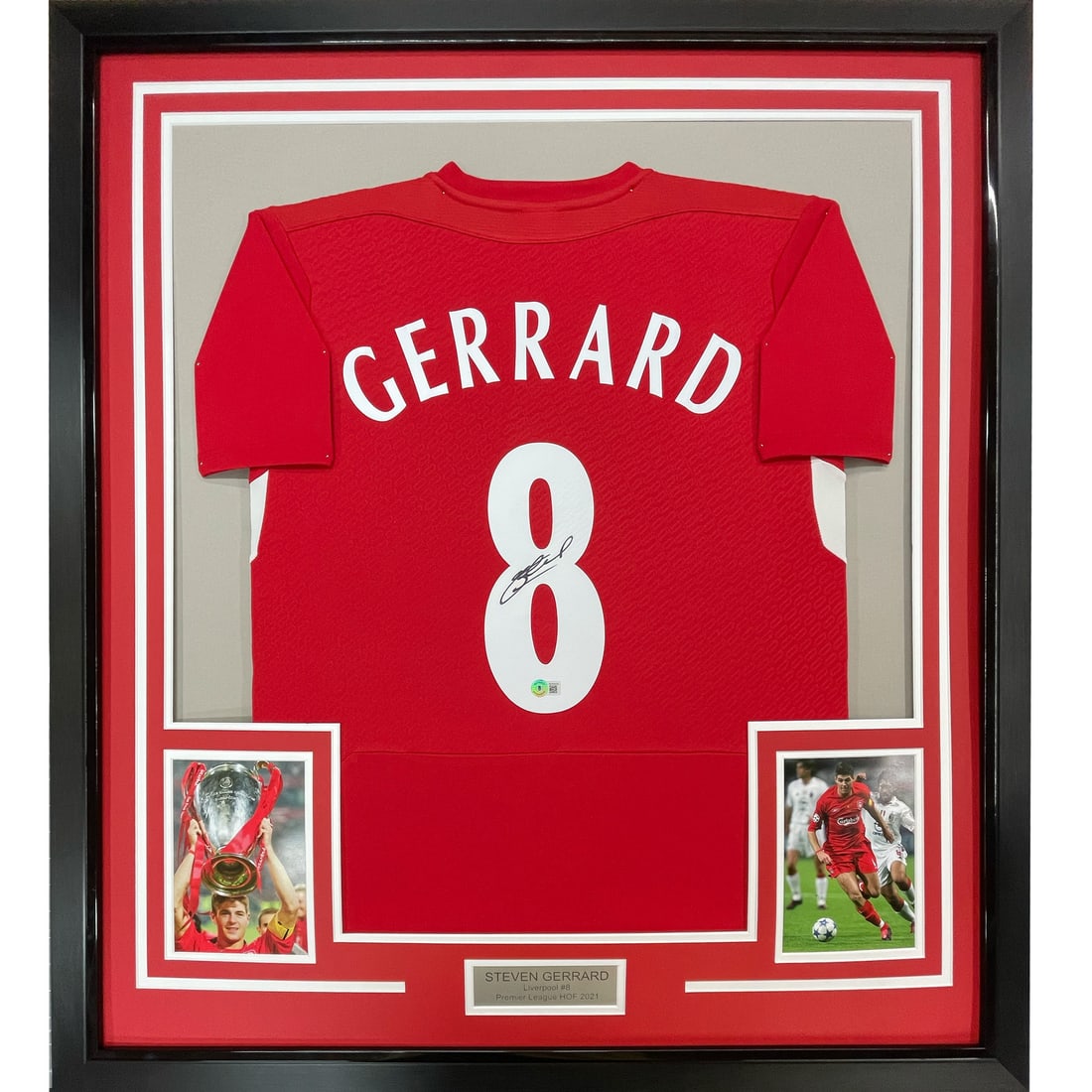 Framed Steven Gerrard Autographed Liverpool Jersey with BAS COA: Framed Steven Gerrard Autographed Liverpool Jersey with BAS COA This stunning framed autographed jersey features the signature of soccer legend Steven Gerrard. Measuring 33" x 42", the vibrant red Liv