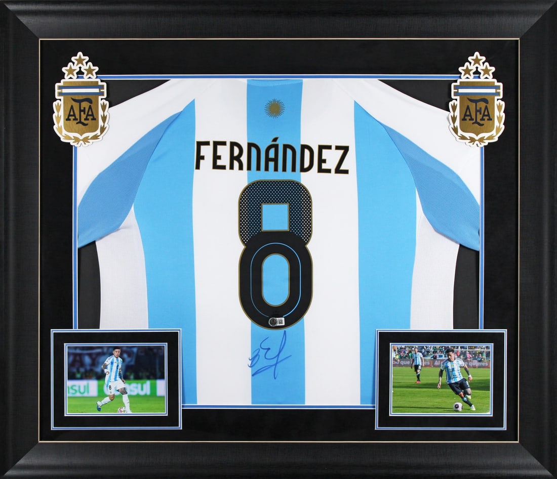 Framed Argentina Blue White Jersey Signed by Enzo Fernandez BAS BU16927: Framed Argentina Blue White Jersey Signed by Enzo Fernandez BAS BU16927 This autographed blue and white Argentina framed jersey has been personally signed by Enzo Fernandez. It is an original item
