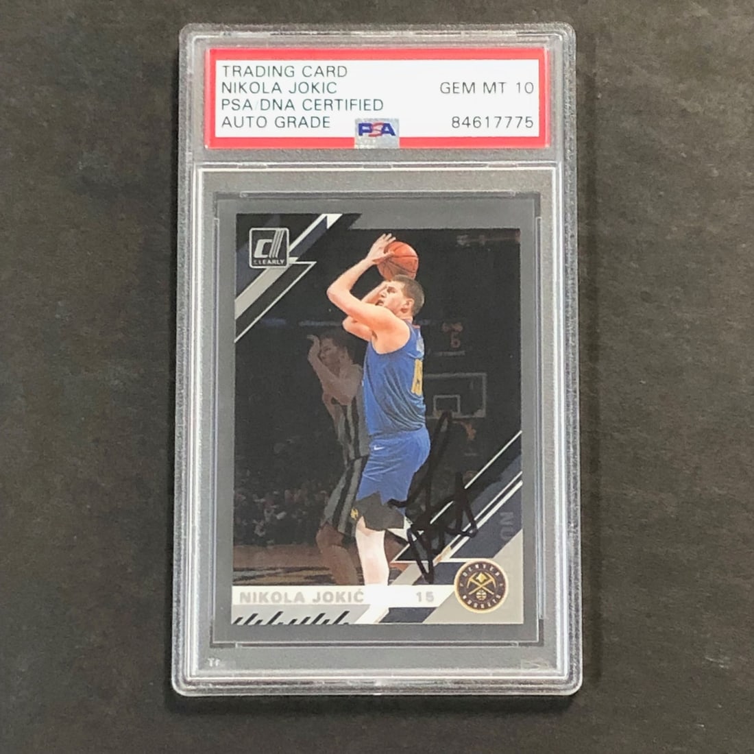 Nikola Jokic signed 2019-20 Donruss Clearly PSA authenticated Nuggets card: Nikola Jokic signed 2019-20 Donruss Clearly PSA authenticated Nuggets card This is an original 2019-20 DONRUSS CLEARLY #11 basketball trading card featuring Nikola Jokic of the Denver Nuggets. The car