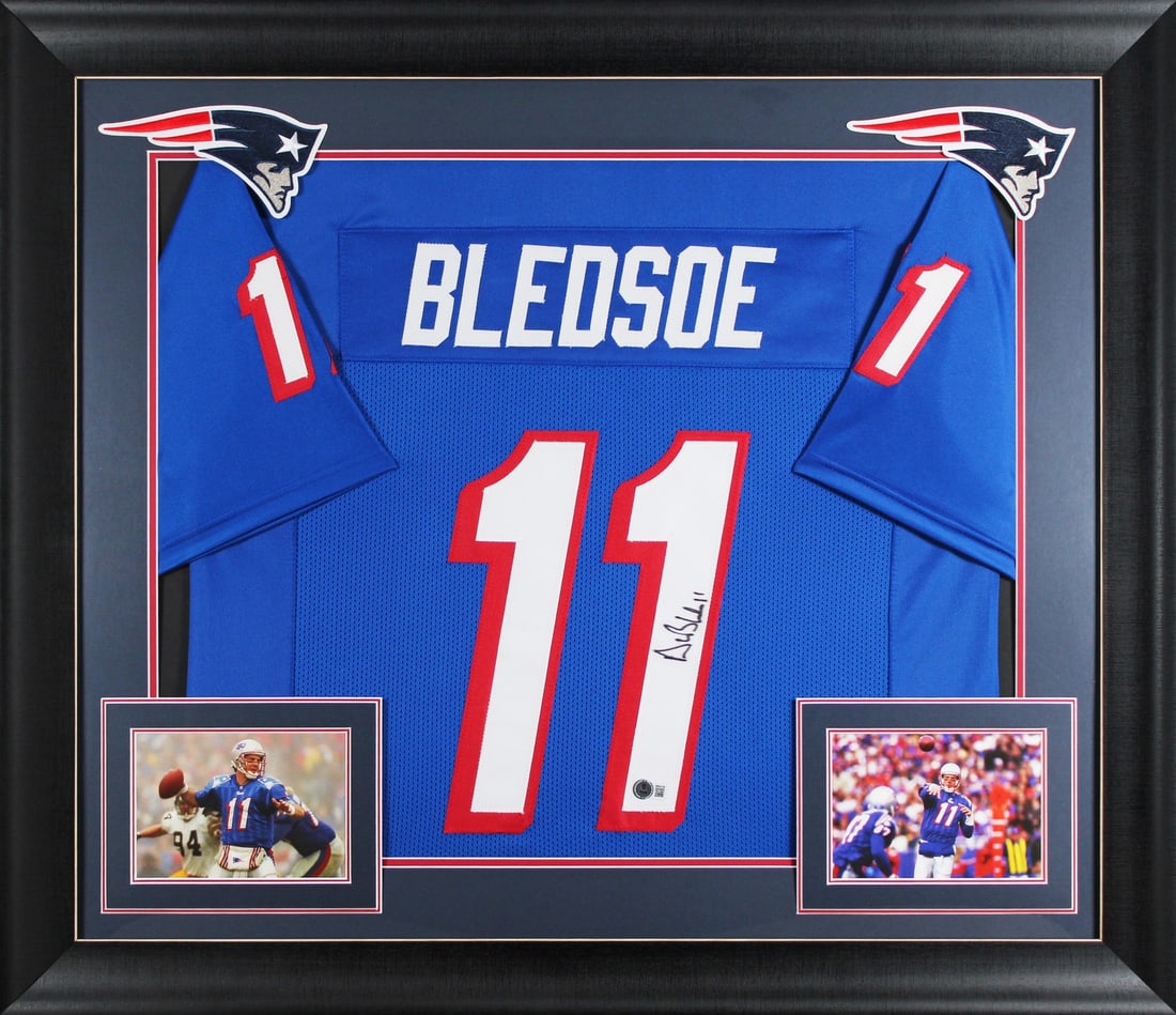 Framed Drew Bledsoe Autographed Throwback Blue Jersey BAS Witnessed: Framed Drew Bledsoe Autographed Throwback Blue Jersey BAS Witnessed Professionally framed throwback blue pro style jersey signed by Drew Bledsoe of the New England Patriots. This X-Large custom-stitch
