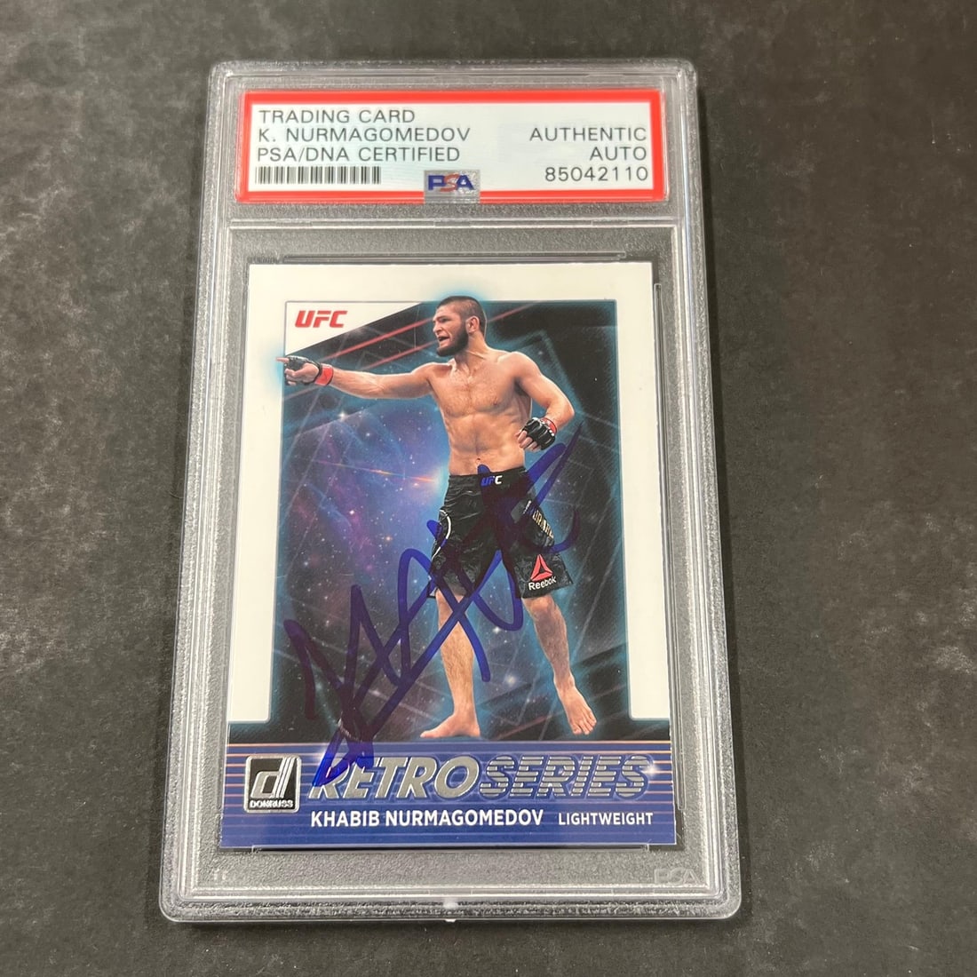 Khabib Nurmagomedov PSA authenticated 2022 Donruss Retro Series card #9: Khabib Nurmagomedov PSA authenticated 2022 Donruss Retro Series card #9 This 2022 Panini Donruss #9 trading card features Khabib Nurmagomedov and is personally signed by the athlete. The autograph has