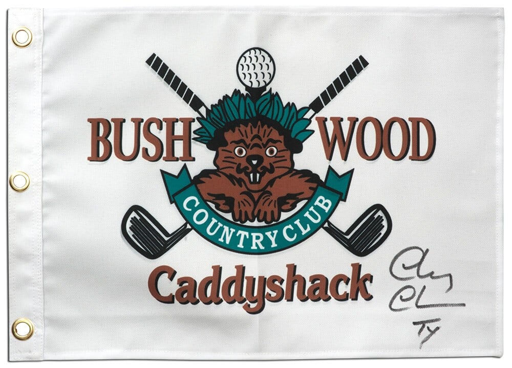 Chevy Chase Signed Caddyshack Golf Pin Flag 18x13 with Ty Inscription: Chevy Chase Signed Caddyshack Golf Pin Flag 18x13 with Ty Inscription Own a piece of cinematic history with this original Chevy Chase signed Caddyshack Bushwood 18x13 golf pin flag. This unique collec