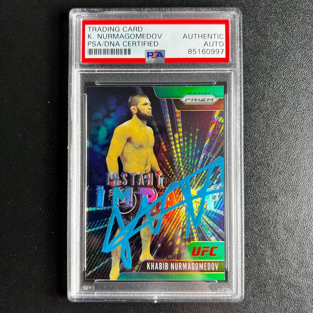 2021 Panini Prizm Khabib Nurmagomedov Signed Card PSA Authenticated: 2021 Panini Prizm Khabib Nurmagomedov Signed Card PSA Authenticated This is a 2021 Panini Prizm #2 sports trading card featuring the signature of renowned MMA fighter Khabib Nurmagomedov. The card is 