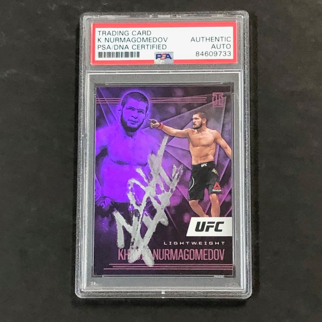 2021 Panini Illusions Khabib Nurmagomedov Signed Card PSA Authenticated: 2021 Panini Illusions Khabib Nurmagomedov Signed Card PSA Authenticated This is a 2021 Panini Illusions #164 trading card featuring Khabib Nurmagomedov, the renowned Mixed Martial Arts (MMA) fighter a