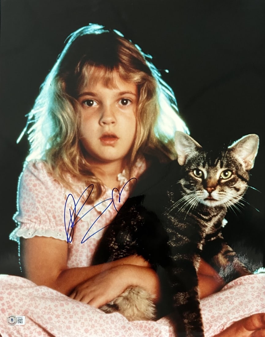 Drew Barrymore Signed 16x20 Cat's Eye Photograph Beckett Certified: Drew Barrymore Signed 16x20 Cat's Eye Photograph Beckett Certified This stunning 16x20 photograph features actress Drew Barrymore, known for her role in the Stephen King movie 'Cat's Eye.' The photogr