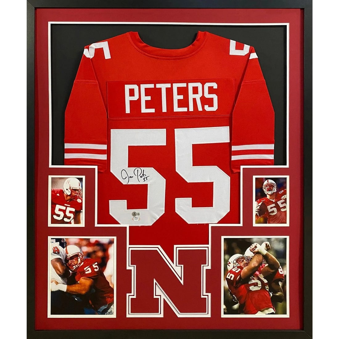 Beckett Autographed Nebraska Framed Jason Peters Jersey: Beckett Autographed Nebraska Framed Jason Peters Jersey This framed Nebraska jersey is autographed by Jason Peters and features detailed framing with a prominent team logo. The jersey is authenticated