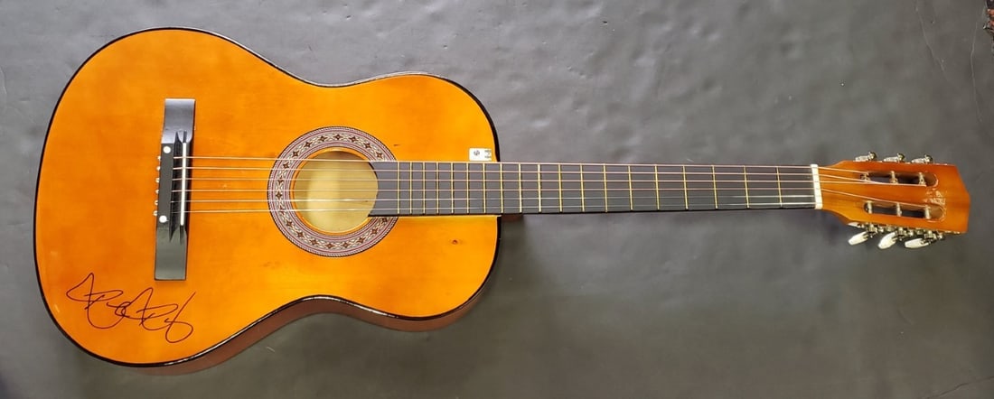 Ronda Rousey signed guitar with pick GAI authenticated: Ronda Rousey signed guitar with pick GAI authenticated This guitar and guitar pick have been hand signed by Ronda Rousey, the renowned MMA fighter and wrestler. The autograph is authenticated by Globa