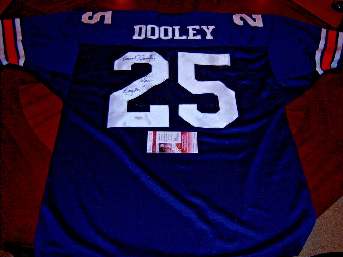 Signed Vince Dooley Football Jersey JSA COA Georgia Bulldogs Auburn Tigers: Signed Vince Dooley Football Jersey JSA COA Georgia Bulldogs Auburn Tigers This is a pre-owned football jersey signed by Vince Dooley. The jersey represents both the Auburn Tigers and Georgia Bulldogs