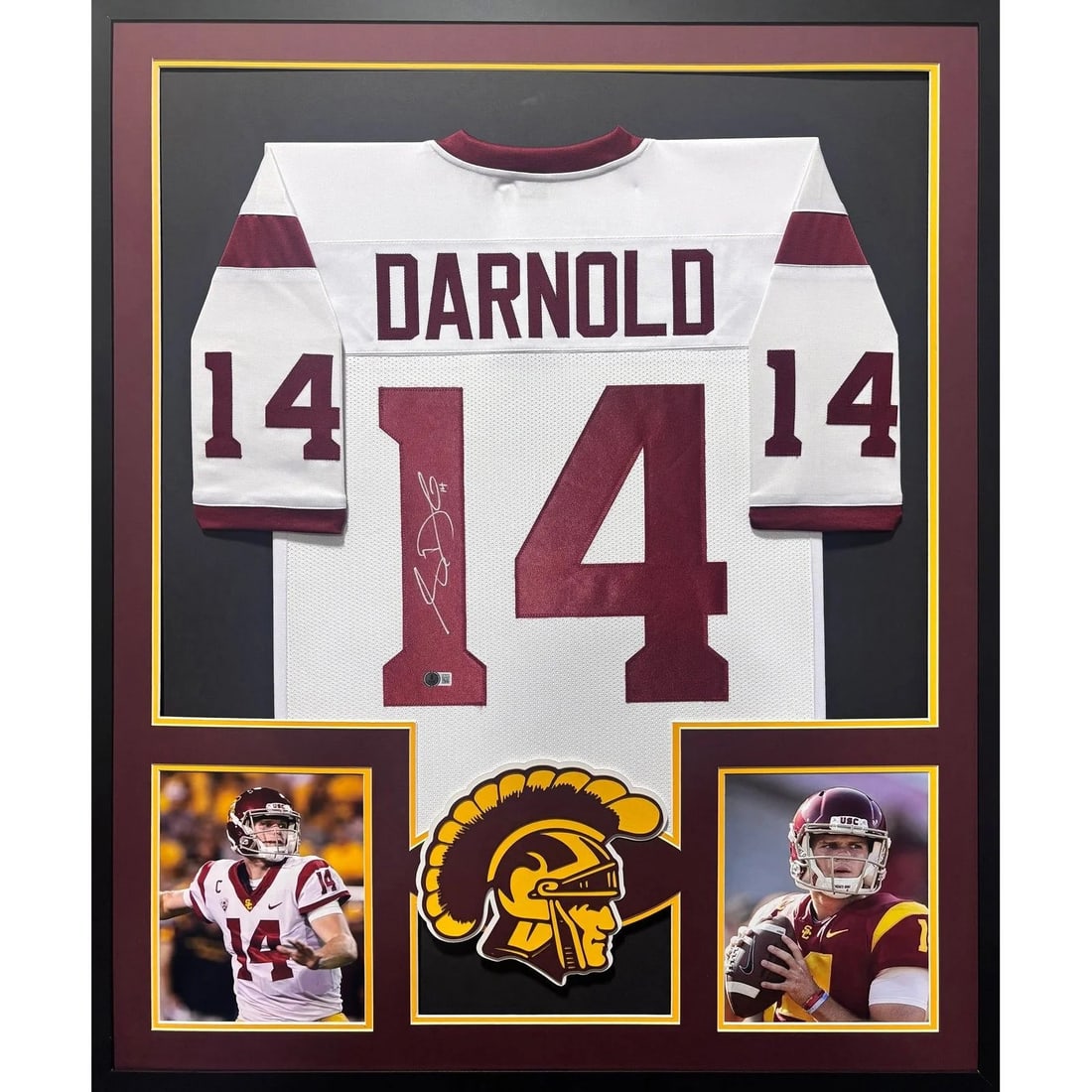 Framed USC White Jersey Signed by Sam Darnold Beckett COA: Framed USC White Jersey Signed by Sam Darnold Beckett COA This is a framed white USC jersey autographed by Sam Darnold. The jersey has been authenticated by Beckett and includes a tamper-proof sticker