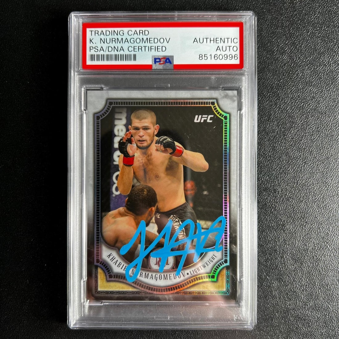 PSA Slabbed Khabib Nurmagomedov Autographed 2018 Panini Prizm Card #18: PSA Slabbed Khabib Nurmagomedov Autographed 2018 Panini Prizm Card #18 This is a 2018 Panini Prizm #18 sports trading card featuring Khabib Nurmagomedov from the Ultimate Fighting Championship (UFC). 