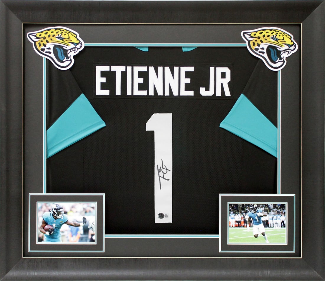 Travis Etienne Signed Black Pro Style Framed Jersey BAS Authenticated: Travis Etienne Signed Black Pro Style Framed Jersey BAS Authenticated This Authentic Signed Black Pro Style Framed Jersey has been personally signed by Travis Etienne, star player of the Jacksonville 
