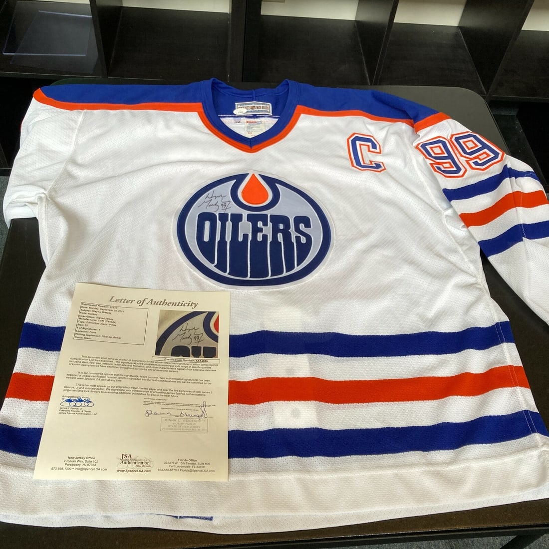 Signed Edmonton Oilers Jersey by Wayne Gretzky with JSA Full Letter COA: Signed Edmonton Oilers Jersey by Wayne Gretzky with JSA Full Letter COA This is an authentic Edmonton Oilers game model jersey, size 52, signed on the front logo in black marker by Hall of Fame center