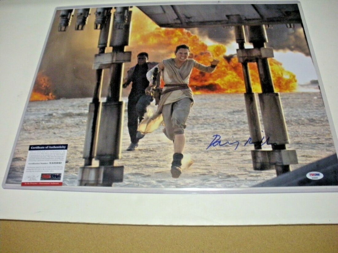 Signed 16x20 Daisy Ridley Photo as Rey with PSA DNA Authentication: Signed 16x20 Daisy Ridley Photo as Rey with PSA DNA Authentication This is a 16x20 photo signed by Daisy Ridley, known for her role as Rey in the Star Wars franchise. The photograph is an original ite