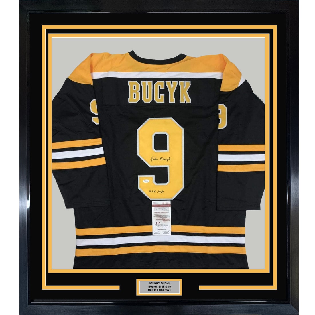 Framed Autographed Johnny Bucyk Jersey Boston Bruins JSA COA 33x42: Framed Autographed Johnny Bucyk Jersey Boston Bruins JSA COA 33x42 Celebrate the legacy of Johnny Bucyk with this professionally framed and autographed Boston Bruins hockey jersey. This item features 